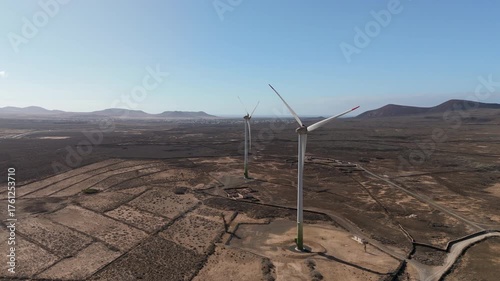 tow wind turbine working in the desert - Canary islands - aerial view drone 4k