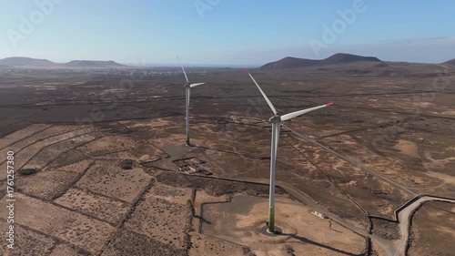 tow wind turbine working in the desert - Canary islands - aerial view drone 4k