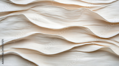 Soft, flowing fabric texture with gentle waves and light cream color creates elegant look