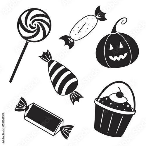A collection of black and white halloween themed treats including a swirl lollipop wrapped candies a jack o lantern and a cupcake in a bucket