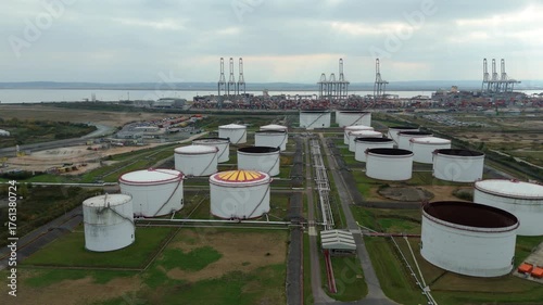 Aerial drone shot of petrochemical fuel and oil storage silos, gas LPG tankers and pipework for energy production, London Port, United Kingdom