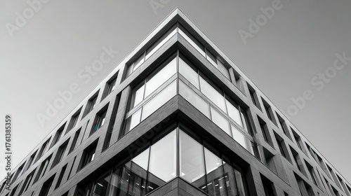 Black and white photo of modern office building exterior. Perfect for architectural design or corporate business concepts.