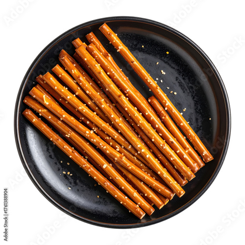 Pretzel sticks  on a black plate isolated white background