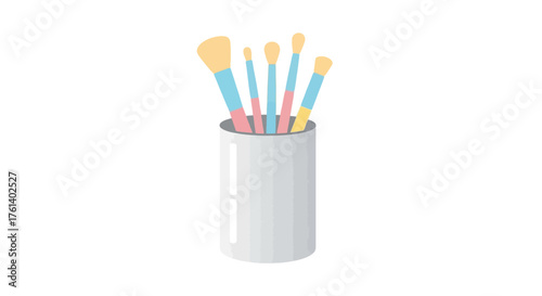 Makeup brushes stand in a cylindrical container displaying various sizes and colors