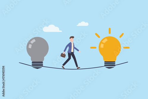 Businessman walking a tightrope between a gray and a glowing yellow light bulb representing ideas
