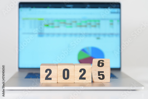 2025 end year to Happy New Year 2026 block with computer laptop background. Goal, Target, Resolution, strategy, plan, Action, mission, motivation, and New Year start concepts