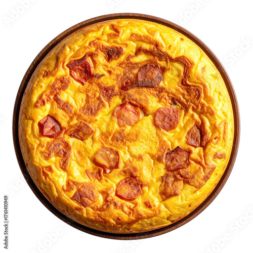 Overhead view of a golden spanish tortilla with chorizo on a wooden plate against a white background isolated white background
