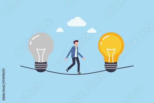 Businessman walking on tightrope between a lit and unlit idea lightbulb symbolizing choice and innovation