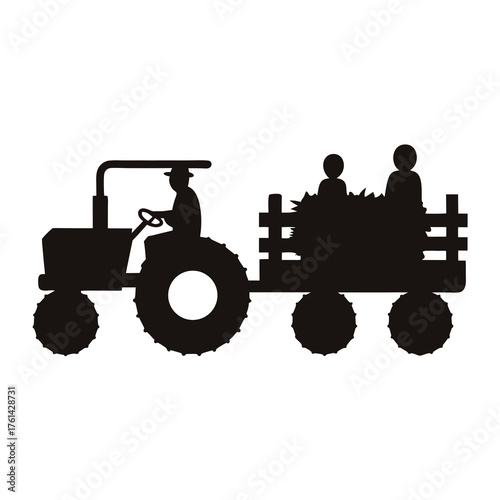 Black silhouette of tractor pulling hayride with people in the cart