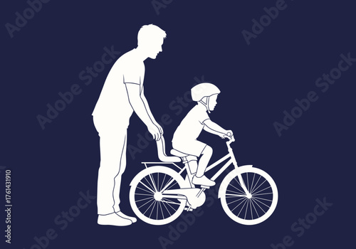 Father helping son ride a bicycle against dark background  