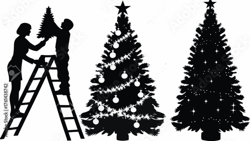 Happy family decorating Christmas trees together silhouetted