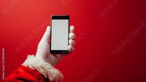 hand of santa clause with white gloves holding a smartphone with a blank screen