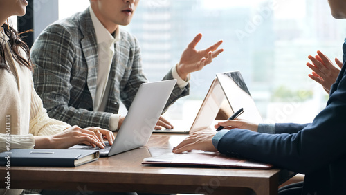 オフィスで会議するカジュアルなビジネスパーソンのグループ