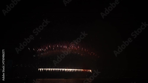 Spectacular new years eve fireworks at Sydney Harbour Bridge 2024 2025 with colorful pyrotechnics, illuminated Opera house and Skyline, view from blues point across the bay, New South Wales, Australia