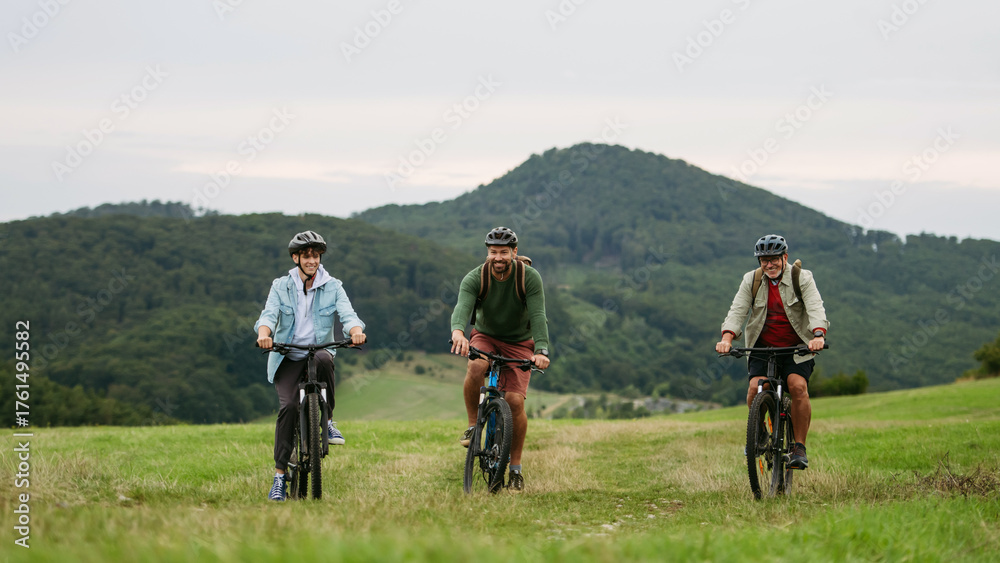 Fototapeta premium Grandfather, father and teen boy on cycling trip in nature.