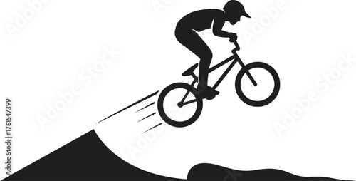 Silhouette of a bmx rider performing a jump on a dirt ramp