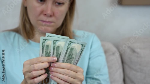 Struggling to manage high utility bills can create stress and anxiety. This clip captures a person's concern while counting cash and worrying about expenses and household budgets.