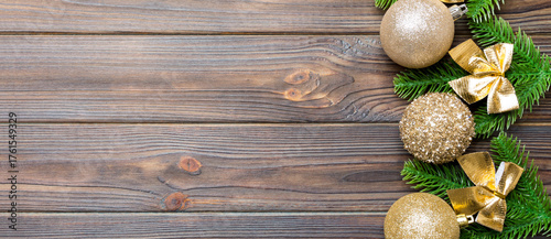 Set of festive balls, fir tree and Christmas decorations on wooden background. Top view of New Year ornament concept with copy space