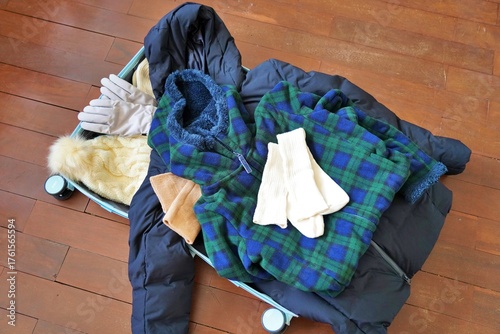 Obraz na płótnie Packing a suitcase for winter travel — cozy layers, warm essentials, and seasona