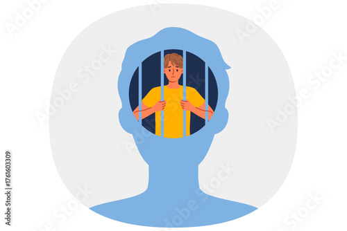 Man hostage to own psychological trauma, sits in prison inside head and needs psychotherapist. Guy with psychological trauma experiences stress and melancholy due to unwillingness to fight for success