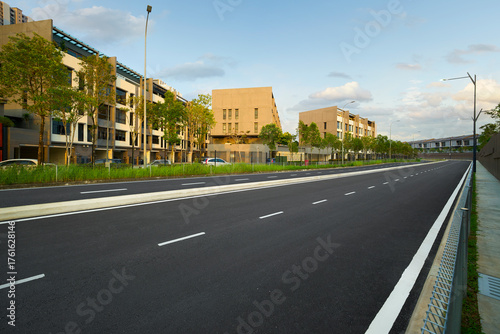Urban street leading past modern apartment buildings