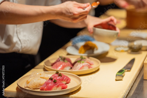 Sushi chef preparing fresh sushi dishes with vibrant ingredients on display