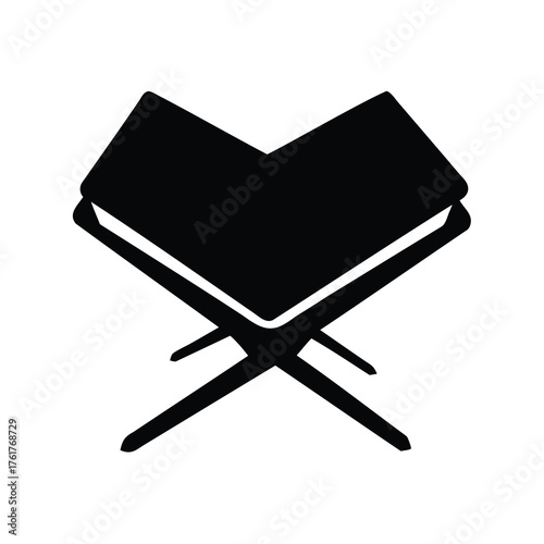 Black and white image of an open book on a wooden stand