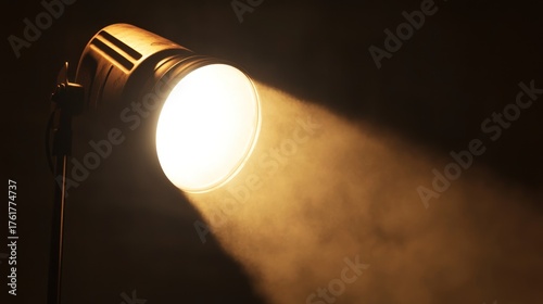 Studio spotlight illuminates dark scene