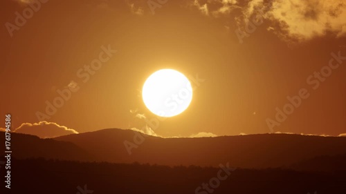 Sunrise timelapse in mountain. Big sun close-uo and clouds motion. Nature composition.
