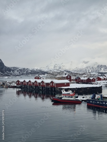 Svolvaer in Lofoten islands during winter, with traditional Norwegian rorbu houses and snowy mountains
