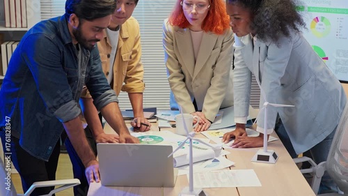 Multi-ethnic business professionals collaborate in a modern office at night, engaging in an agile transformation meeting focused on digital innovation, business shift strategy, data-driven decision-ma