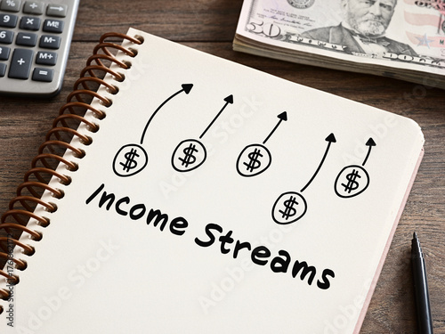 Income streams increasing shown on notebook with calculator and us dollars