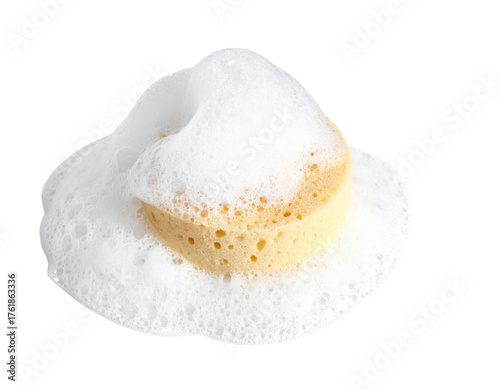 A yellow sponge covered with white foam, showcasing its porous texture and bubbly surface.