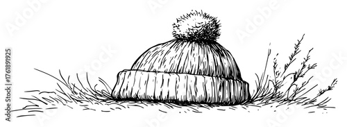 Hand drawn winter beanie hat with pom pom on meadow black and white vector line art illustration