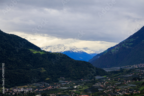 Mountain panorama with snowcapped mountains and summit Laaser Spitze (Orgelspitze) in Ortler Alps and valley Etschtal on a cloudy day in autumn in South Tyrol, Italy
