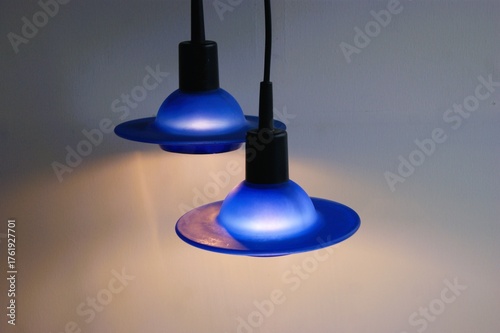 Pair of pendant light in glowing blue glass.