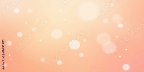 Soft focus glowing bokeh lights on a warm peach and pink gradient background