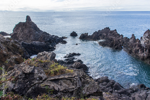 The Poças do Governador in Madeira are natural volcanic pools near São Vicente, where dark rocks meet crystal-clear Atlantic waters, creating a peaceful spot for swimming and relaxation.