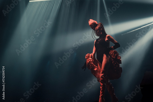 Avant-garde nightclub performer on stage—elegant, seductive and powerful. Dramatic spotlights, cinematic haze and confident pose create a high-fashion, theatrical party vibe.
