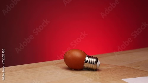 A hammer smashing an egg lightbulb in slow motion. Destroyed growing ideas concept. Destroyed dreams concept. Hammer smashing an egg