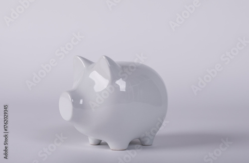 A white piggy bank on a pla...