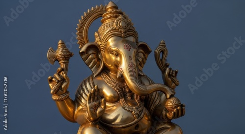 Wallpaper Mural Golden ganesha sculpture against blue background for home decor and spiritual spaces Torontodigital.ca