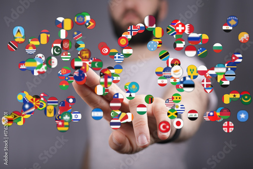 Conceptual image of a person interacting with floating flags representing different nations, symbolizing globalization and international relatio