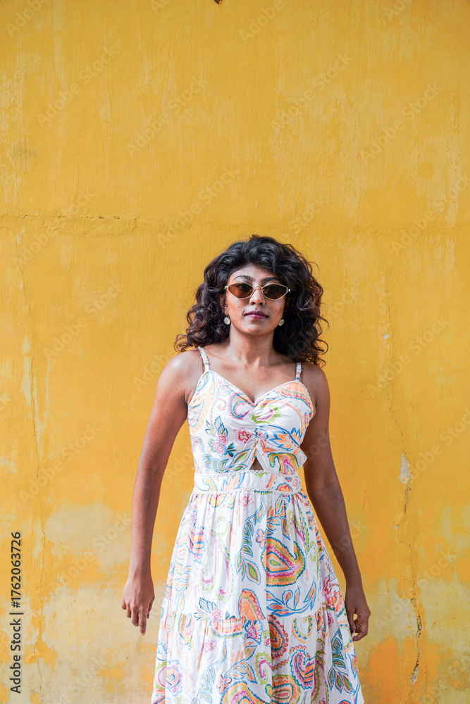 Fototapeta premium She is wearing sunglasses and has her arms crossed