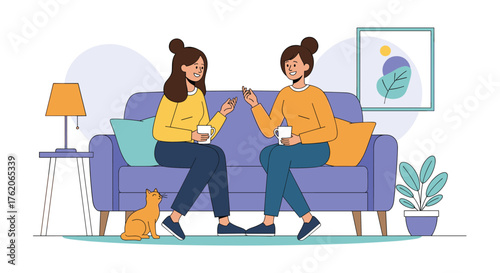 Two women chatting over coffee on a sofa with a cat nearby.