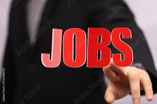 Person points to 'JOBS', sy...