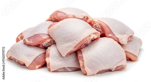 Pile of raw chicken thighs isolated on a white background ready for cooking