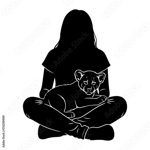 Person holding lion cub sitting cross-legged
