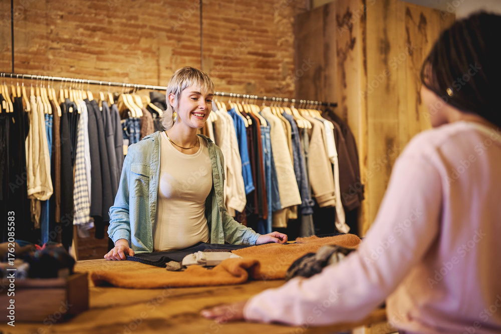 Fototapeta premium Young woman smiling at boutique counter during shopping experience