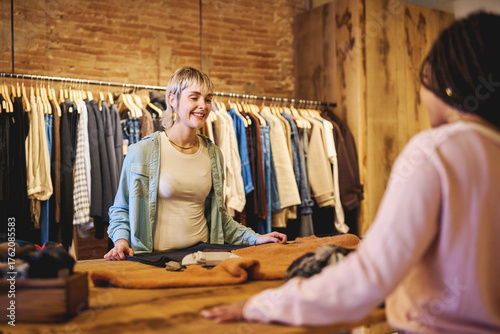 Young woman smiling at boutique counter during shopping experience